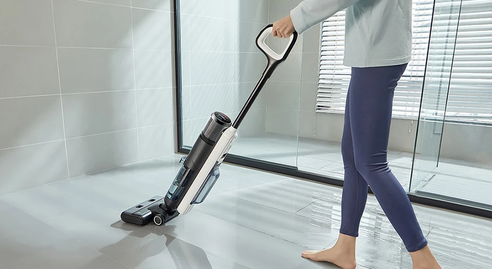 Ultenic AC1 Elite a person holding a vacuum cleaner