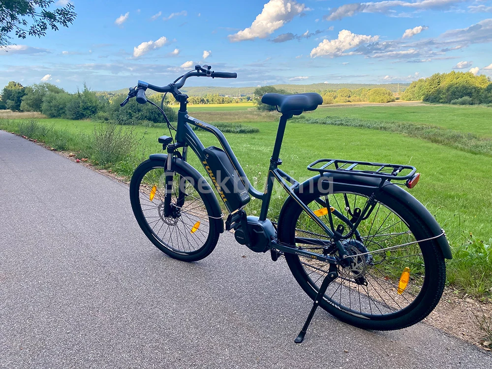 Touroll MA2 Vélo électrique, moteur central 250 W, batterie 36 V 13 Ah, pneus 27,5 pouces, vitesse maximale 25 km/h, autonomie maximale 100 km, frein à disque hydraulique, fourche à suspension avec blocage, transmission Shimano 7 vitesses - Gris