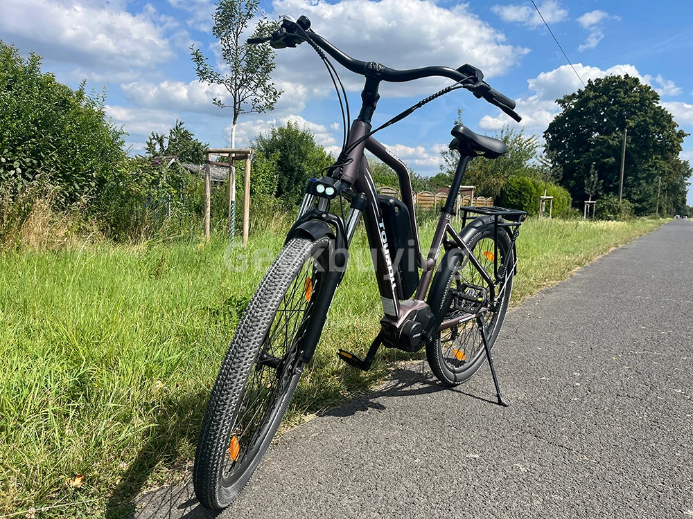 Touroll MA2 Vélo électrique, moteur central 250 W, batterie 36 V 13 Ah, pneus 27,5 pouces, vitesse maximale 25 km/h, autonomie maximale 100 km, frein à disque hydraulique, fourche à suspension avec blocage, transmission Shimano 7 vitesses - Gris